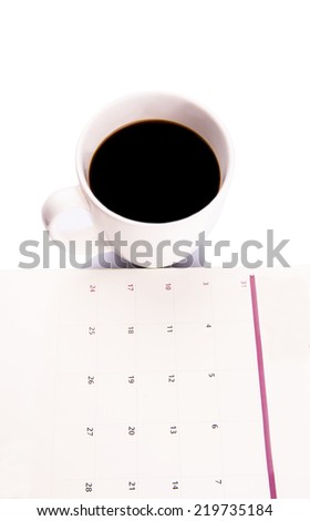 A mug of coffee and table day planner