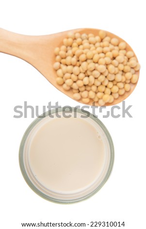 Soybean on wooden spoon with a glass of soybean milk