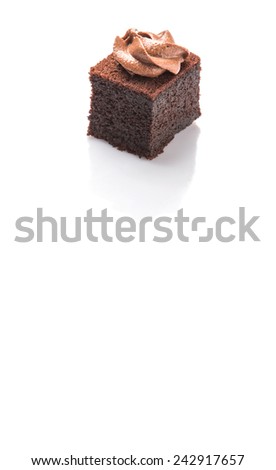 Bite sized chocolate cake with icing on top over white background