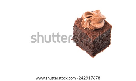 Bite sized chocolate cake with icing on top over white background