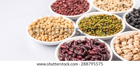 Black eye peas, mung bean, adzuki beans, chickpeas, soy beans, black beans and red kidney beans in white bowl over white background
