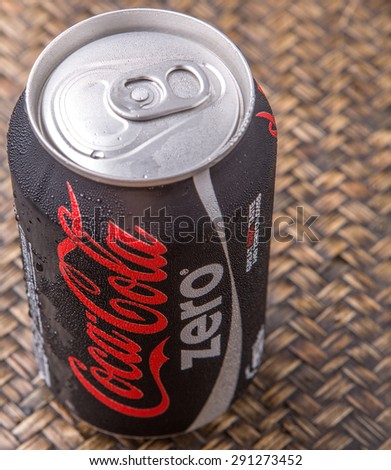PUTRAJAYA, MALAYSIA - JUNE 28TH, 2015. Coca Cola Zero on wicker background. Coca Cola drinks are produced and manufactured by The Coca-Cola Company, an American multinational beverage corporation.