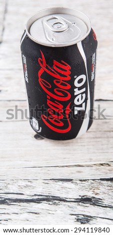 PUTRAJAYA, MALAYSIA - JULY 5TH, 2015. Coca Cola Zero on weathered wood. Coca Cola drinks are produced and manufactured by The Coca-Cola Company, an American multinational beverage corporation.
