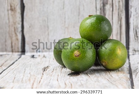 Calamansi citrus over weathered wooden background