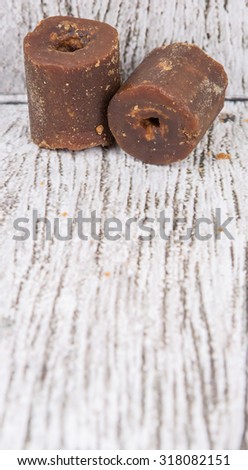 Brown coconut sugar over wooden background