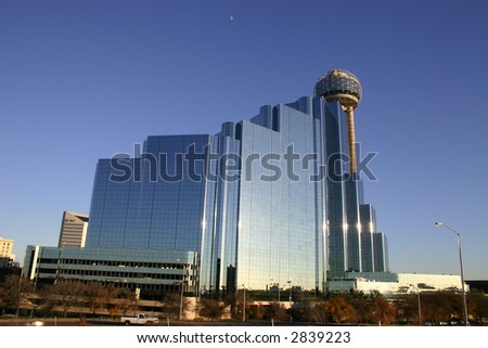 Dallas skyline and moon against blue sky at sunset