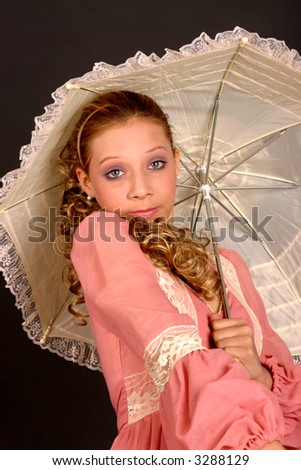 Blond teenage girl with parasol and wearing period costume dress