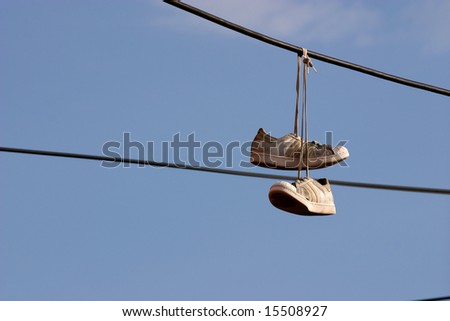 Sneakers hanging on a phone wire by a Los Angeles street gang to mark heroin drug sale area