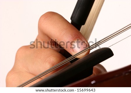 Close up of fingers plucking strings of violin with white background and bow