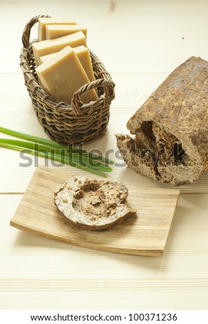african black soap and handmade natural soaps in basket on wooden