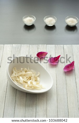 alternative therapy setting: vanilla petals in china dish, bath salts in glass bowls and peony petals