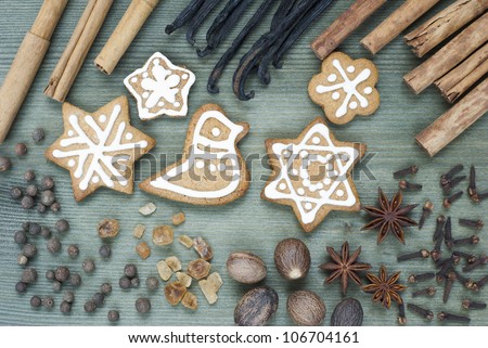 gingerbread figurines and dessert spices, wooden table background