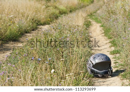 broken safety helmet, coutryside road after motorbike rally