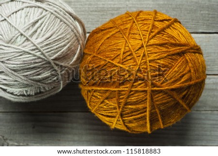 wool ball of threads on wooden table