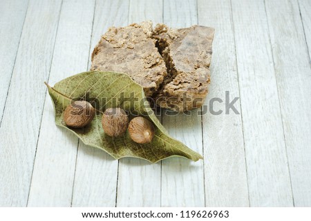 handmade african black soap and ingredients, shea butter nuts, leaves and white shea butter