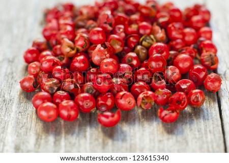 rose pepper on  rustic wood table