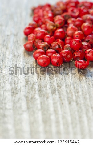 rose pepper on  rustic wood table