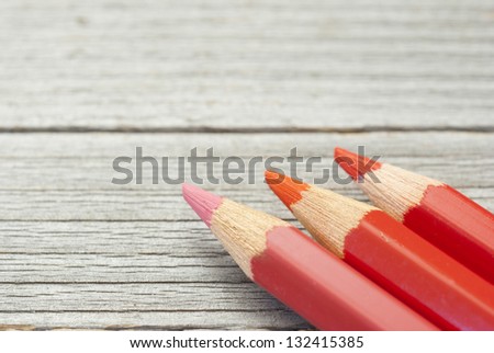 warm color pencils on wood table