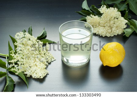 glass of natural elder flower juice with lemon and elder flowers