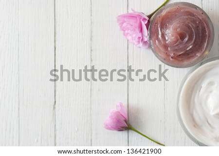 cosmetic cream with japanese cherry blossoms on white wooden table