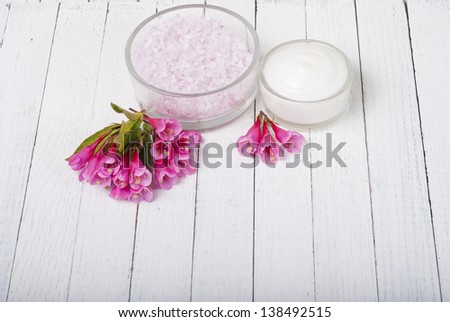 acne cream, bath salts on white wood table