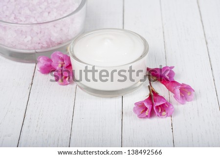 acne cream, bath salts on white wood table