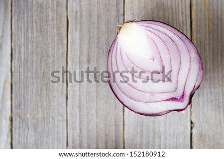 half cut spanish onion on old wood table