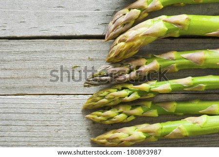 fresh green asparagus, old wood table background, directly above