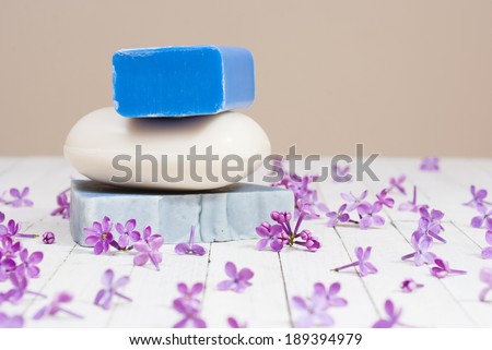 soaps with lilac flowers on white wood table