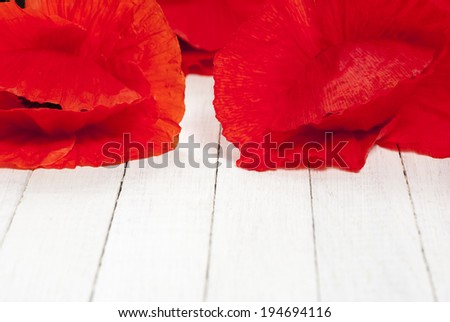 red poppy flowers on white wood table background