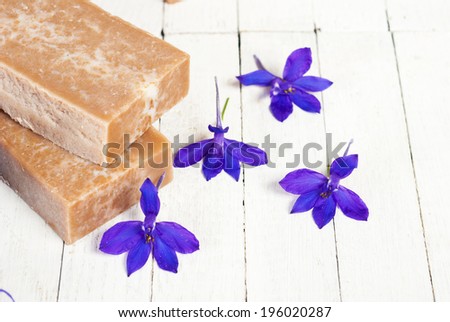 marble pattern homemade soap blocks with purple flowers on white wooden
