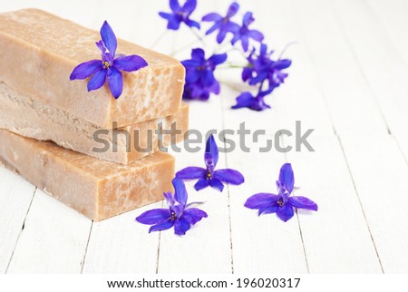 marble pattern homemade soap blocks with purple flowers on white wooden