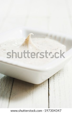 facial cleanser on white wooden background