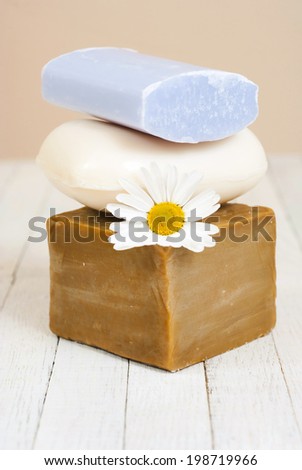 soap stack with chamomile flower on white wood table