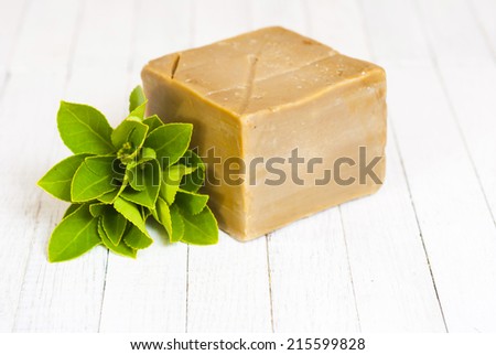 organic soap block with fresh herbal leaves