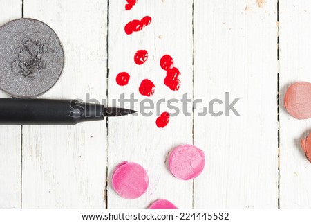 makeup accessories on white wood table