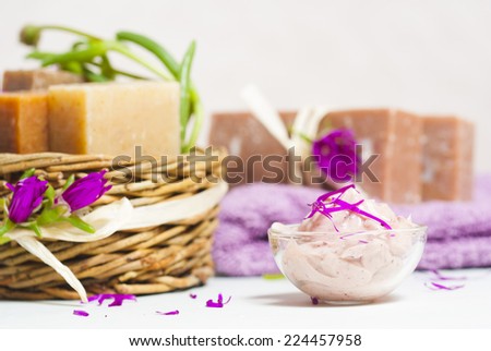soaps and cosmetic cream in glass bowl on white wood table