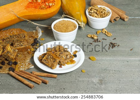 pumpkin cake and ingredients, aged wood table background