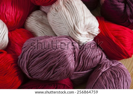 balls of wool on bamboo dish, rusty wood table background