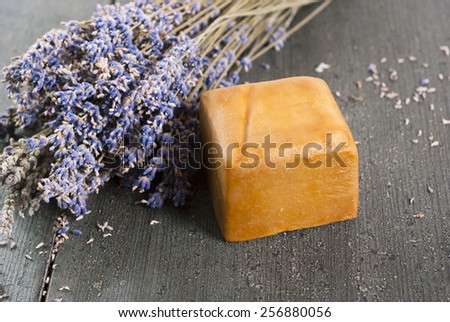 organic soap with blue lavender bouquet on dark wooden table