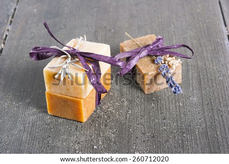 lavender soaps and flowers on rusty black wooden