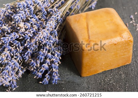 organic soap with blue and white lavender bouquets on dark wooden table