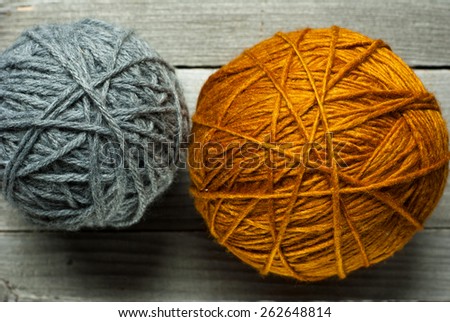 wool ball of threads on wooden table