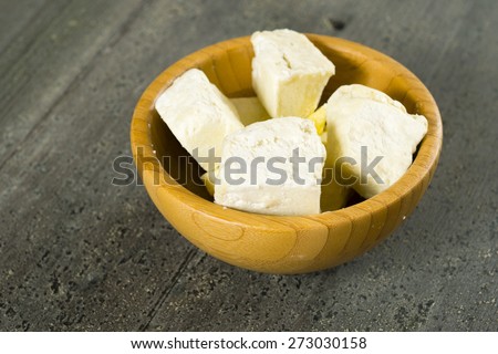 shea butter in bamboo bowl, dark wood table background
