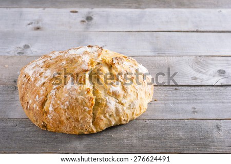 rustic homemade loaf on weathered natural wood table