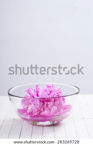 floating flower in aroma bowl on white wooden