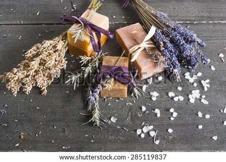 organic soaps with blue and white lavender bouquets on dark wooden table
