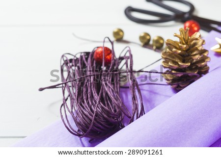 christmas gift packaging with purple papers and cards with christmas tree print