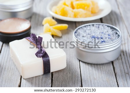 Calendula cream, lip balm, raw bees wax, bath salt soap and other cosmetics on rusty wood table