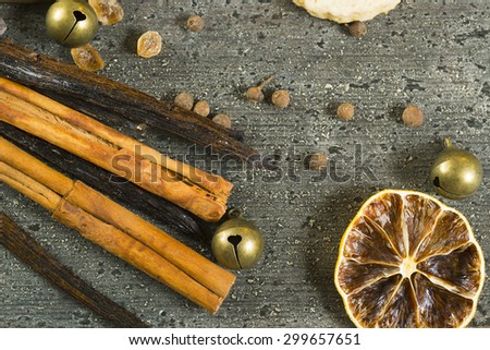 cakes on baking tin with dehydrated citrus fruits and dessert spices on dark rusty wooden table